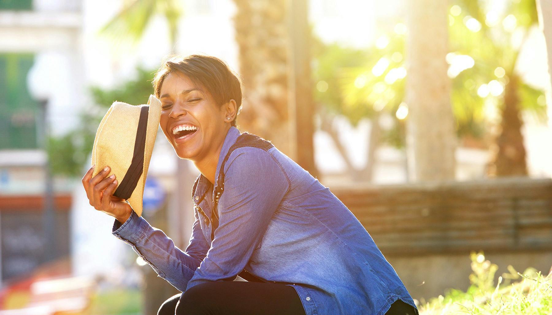 A woman sitting outside smiling